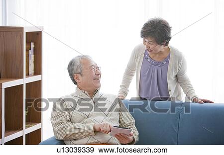Mature Couple In Living Room View Large Photo Image Stock Photo - Mature Couple In Living Room. Fotosearch