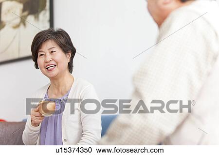 Mature Couple In Living Room With Coffee View Large Photo Image Stock Image - Mature Couple In Living Room With Coffee. Fotosearch