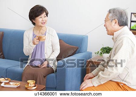 Mature Couple In Living Room With Coffee and Cake View Large Photo Image Stock Image - Mature Couple In Living Room With Coffee and Cake. Fotosearch