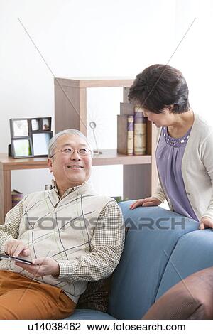 Mature Couple Using Digital Tablet In Living Room View Large Photo Image Stock Image - Mature Couple Using Digital Tablet In Living Room. Fotosearch