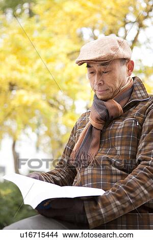 Mature Man Reading In Park In Autumn View Large Photo Image Picture - Mature Man Reading In Park In Autumn. Fotosearch