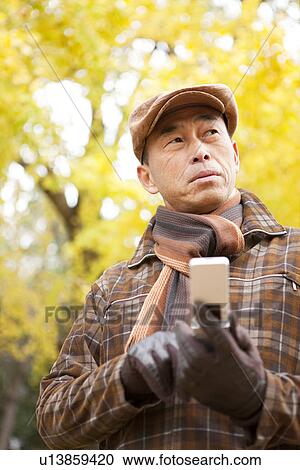 Mature Man Walking In the Woods In Autumn View Large Photo Image Stock Image - Mature Man Walking In the Woods In Autumn. Fotosearch