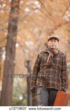 Mature Man Walking In the Woods In Autumn View Large Photo Image Stock Photo - Mature Man Walking In the Woods In Autumn. Fotosearch