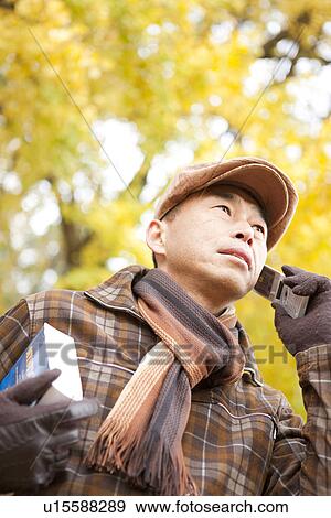 Stock Photo - Mature Man Walking In the Woods In Autumn. Fotosearch