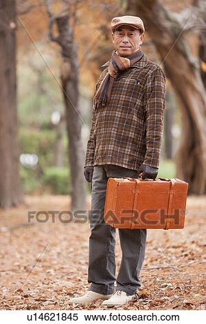 Mature Man Walking In the Woods In Autumn View Large Photo Image Stock Photography - Mature Man Walking In the Woods In Autumn. Fotosearch