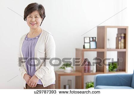 Mature Woman In Living Room View Large Photo Image Stock Image - Mature Woman In Living Room. Fotosearch