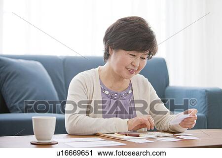 Mature Woman Writing In Living Room View Large Photo Image Stock Image - Mature Woman Writing In Living Room. Fotosearch