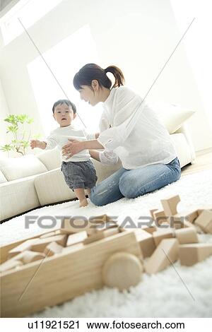 Mother and baby in living room View Large Photo Image Stock Image - Mother and baby in living room. Fotosearch