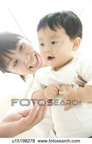 Mother and baby in living room View Large Photo Image Stock Photo - Mother and baby in living room. Fotosearch