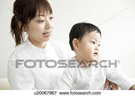 Mother and baby in living room View Large Photo Image Stock Photo - Mother and baby in living room. Fotosearch