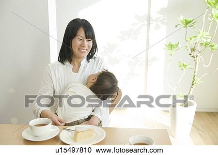 Mother and baby sitting at table View Large Photo Image Stock Image - Mother and baby sitting at table. Fotosearch