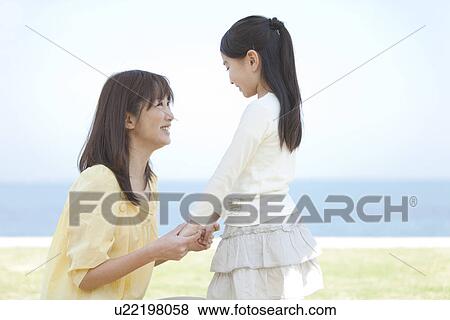 Mother and Daughter Holding Hands and Looking at Each Other View Large Photo Image Stock Photo - Mother and Daughter Holding Hands and Looking at Each Other. Fotosearch