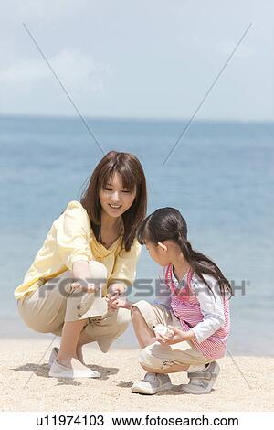 Mother and Daughter Playing on Sand View Large Photo Image Stock Image - Mother and Daughter Playing on Sand. Fotosearch