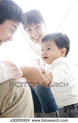Mother and father with baby son View Large Photo Image Picture - Mother and father with baby son. Fotosearch