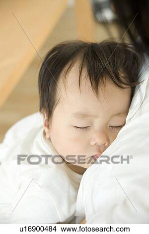 Mother and sleeping baby hugging View Large Photo Image Picture - Mother and sleeping baby hugging. Fotosearch