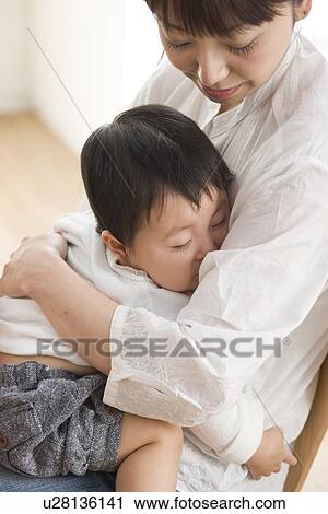 Mother and sleeping baby hugging View Large Photo Image Stock Image - Mother and sleeping baby hugging. Fotosearch