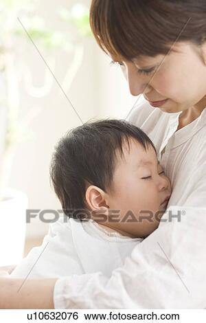 Mother and sleeping baby hugging View Large Photo Image Stock Photograph - Mother and sleeping baby hugging. Fotosearch