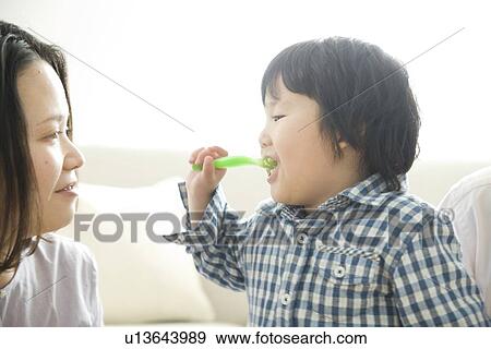Mother and son eating View Large Photo Image Stock Photo - Mother and son eating. Fotosearch