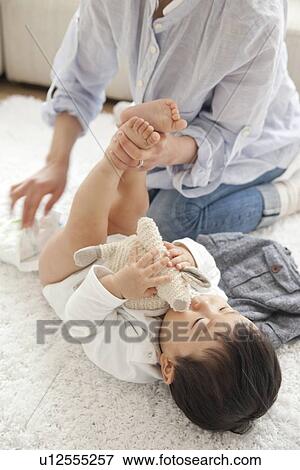 Mother changing diaper View Large Photo Image Stock Photo - Mother changing diaper. Fotosearch