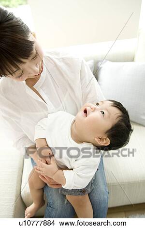 Mother holding baby son View Large Photo Image Picture - Mother holding baby son. Fotosearch