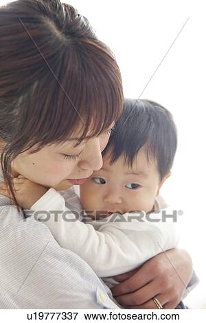 Mother holding baby son View Large Photo Image Stock Photo - Mother holding baby son. Fotosearch