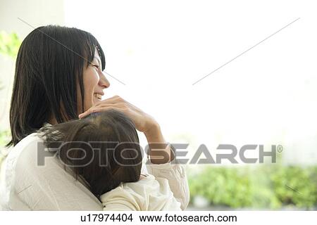 Mother hugging baby View Large Photo Image Picture - Mother hugging baby. Fotosearch