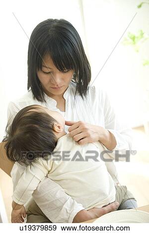 Stock Photo - Mother hugging baby. Fotosearch