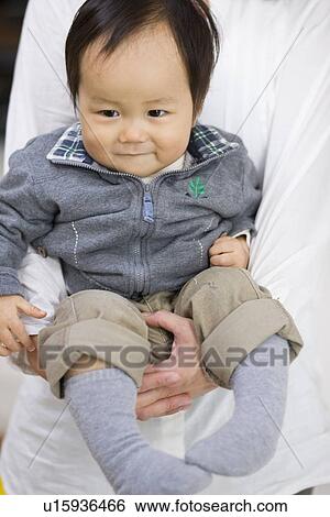 Stock Photograph - Mother hugging baby. Fotosearch