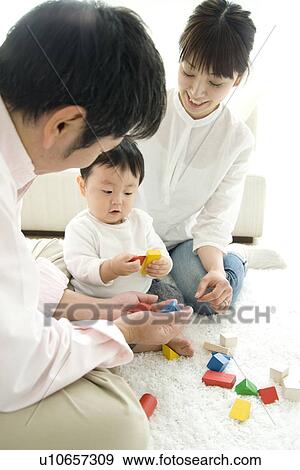 Parents playing with baby boy View Large Photo Image Stock Photo - Parents playing with baby boy. Fotosearch