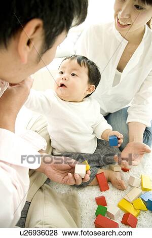 Parents playing with baby boy View Large Photo Image Stock Photo - Parents playing with baby boy. Fotosearch