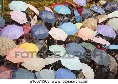 Stock Photo - People in rain, Taipei, Taiwan. Fotosearch