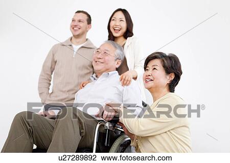 Stock Image - Portrait of Family, Mature Man In Wheelchair. Fotosearch
