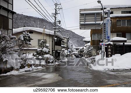 Stock Photograph - Road in snowcapped village. Fotosearch
