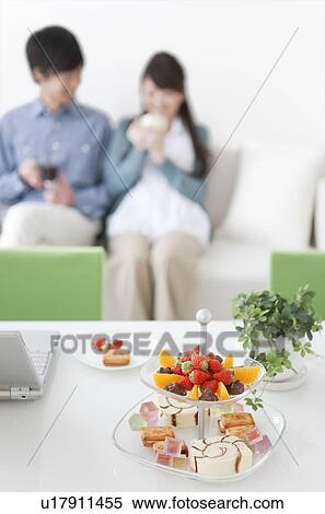 Snacks on Table, Young Couple In Background View Large Photo Image Stock Photography - Snacks on Table, Young Couple In Background. Fotosearch