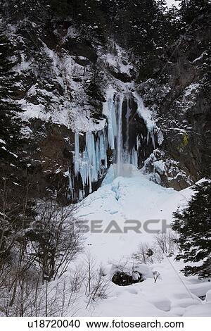 Snowcapped cliff and freezing waterfall View Large Photo Image Stock Image - Snowcapped cliff and freezing waterfall. Fotosearch