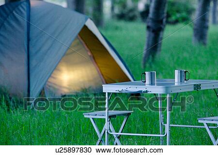 Stock Image - Tent and Two Mugs On Campsite, Early Morning. Fotosearch
