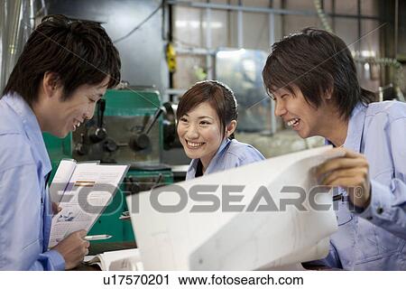 Three Workers Looking at Reports View Large Photo Image Stock Image - Three Workers Looking at Reports. Fotosearch