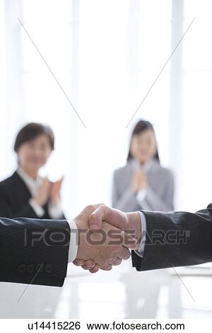 Stock Photograph - Two Businessmen Shaking Hands. Fotosearch