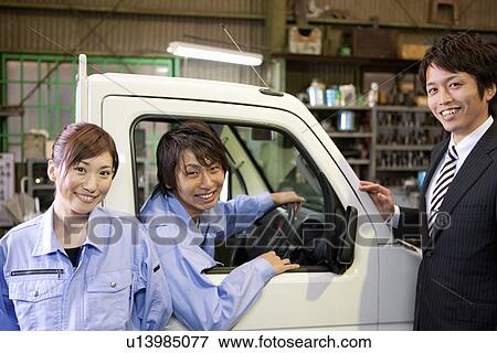 Two Car Mechanics and Businessman View Large Photo Image Stock Photo - Two Car Mechanics and Businessman. Fotosearch