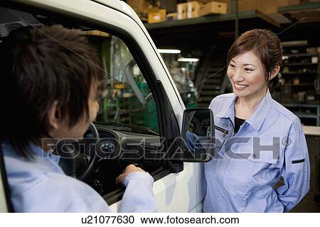 Stock Image - Two Car Mechanics. Fotosearch