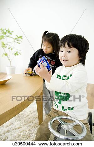 Picture - Two children playing with toys. Fotosearch
