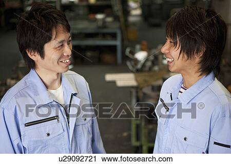 Two Colleagues Talking to Each Other View Large Photo Image Stock Image - Two Colleagues Talking to Each Other. Fotosearch