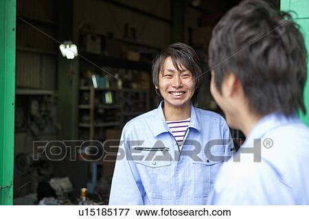 Stock Photo - Two Colleagues Talking to Each Other. Fotosearch
