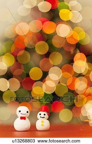 Stock Image - Two Decorative Snowmen and Christmas Lights. Fotosearch