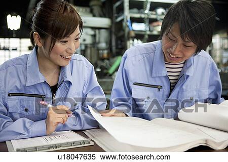 Two Factory Workers Reading Documents View Large Photo Image Stock Photography - Two Factory Workers Reading Documents. Fotosearch