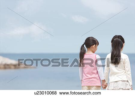 Two Girls Looking at Sea View Large Photo Image Stock Photo - Two Girls Looking at Sea. Fotosearch