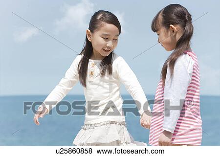 Stock Photo - Two Girls Looking at Sea. Fotosearch