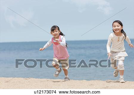 Two Girls Running on Beach View Large Photo Image Picture - Two Girls Running on Beach. Fotosearch