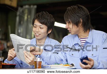 Two Male Workers Reading Newspaper at Lunch Break View Large Photo Image Stock Image - Two Male Workers Reading Newspaper at Lunch Break. Fotosearch