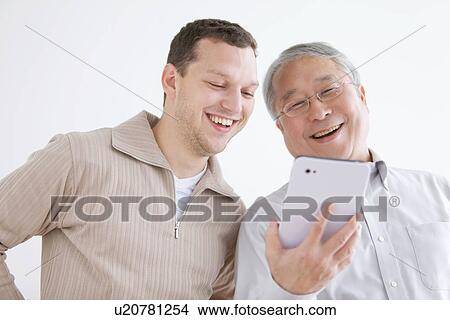 Two Men Using Digital Tablet View Large Photo Image Picture - Two Men Using Digital Tablet. Fotosearch
